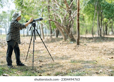 Bird watchers with tripod and spotting scope.