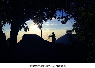 Bird Watching Activity By A Man With A Telescope In The Frame Of The Forest, Silhouette Scene