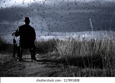 Bird Watching A Composition Showing A Man Sitting On A Chair In A Countryside Holding His Umbrella. He Is Looking At A Flock Of Birds Passing Through