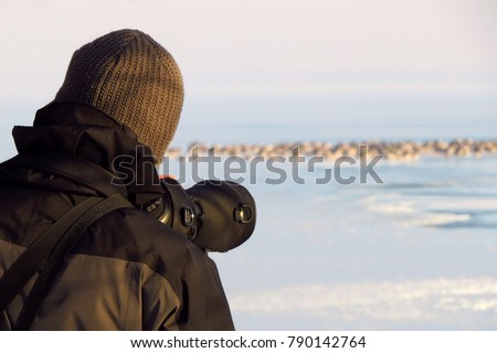 Bird watching with telescope - bird watcher counting birds at IWC International waterbird census - bird count, ornithologist