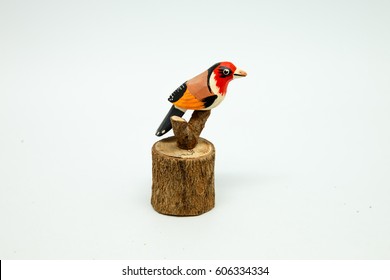 Bird wooden carving is sold in souvenir shops. Isolated on white background
