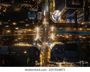 Bird's eye night view of Kyoto, Japan's bustling intersection with traffic flow, buildings rooftops and illuminated urban landscape - Powered by Shutterstock