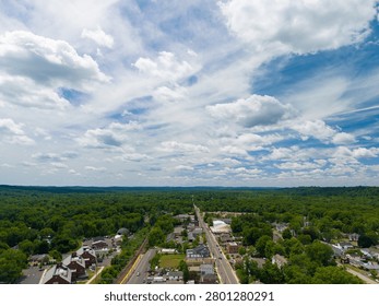Bird's eye perspective capturing a tree lined main road through an attractive suburban town