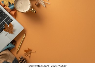 Bird's eye top view of autumnal freelance workstation, complete with a laptop, gilded pen, coffee mug, scarf and charming autumnal decorations on brown background. Perfect for text or advert placement - Powered by Shutterstock