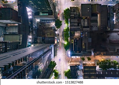 Bird's Eye View Of City Streets And High Rise Skyscrapers At Night