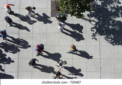 A Bird's Eye View Of A Crowd Of People Strolling Down A Sidewalk.