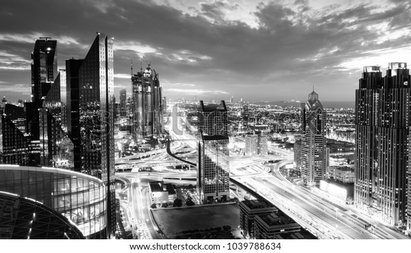 Bird\'s eye view of Dubai skyline and rush hour\
traffic in downtown at\
night