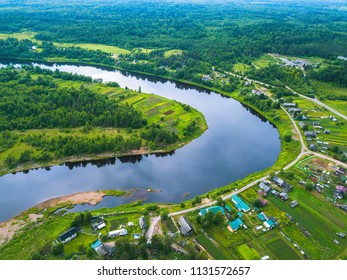 Bird's eye view of the green forests, river and the village. Karelia, Russia.