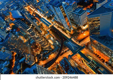 Birds eye view of a modern building at night. Traffic in the business district The Skytrain station Chong Nonsi