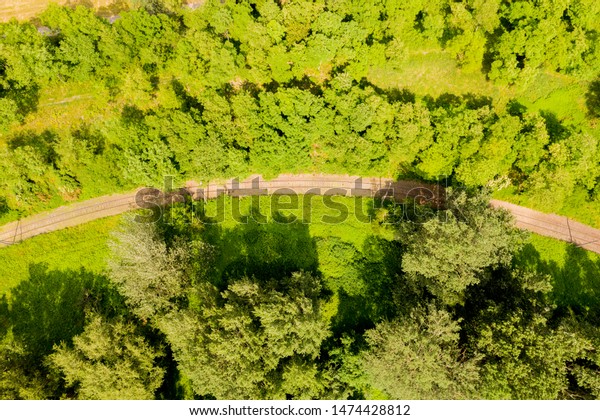 A bird\'s eye view of railroad tracks and the forest.\
Aerial View
