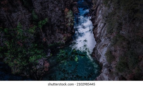 A Bird's Eye View Of A River Among Rocks And Trees