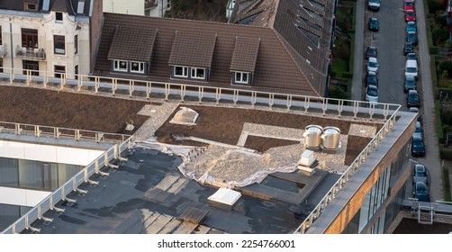 Birds eye view of a roof construction site. Professional placing of gravel stones on a flat roof builing.	 - Shutterstock ID 2254766001