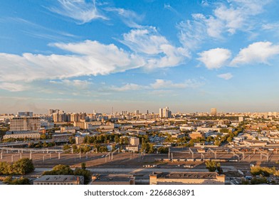 Bird's eye view of the Russian capital Moscow during the golden hour of sunset with long shadows and blue skies and a railroad through the city - Shutterstock ID 2266863891