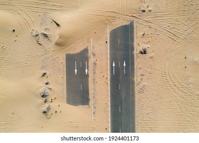 Birds Eye View Of A Sand Covered Empty Road In The Dubai Desert