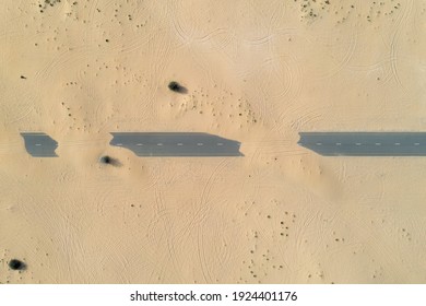 Birds Eye View Of A Sand Covered Empty Road In The Dubai Desert