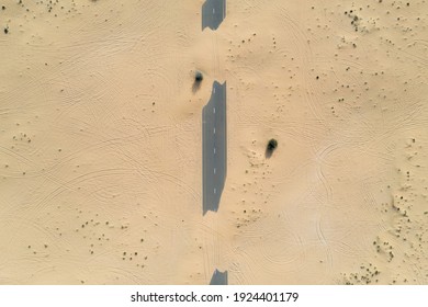 Birds Eye View Of A Sand Covered Empty Road In The Dubai Desert