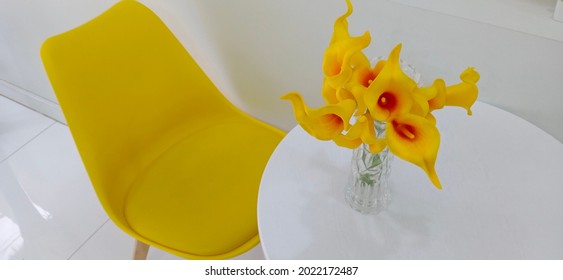 Bird's Eye View Of A Set Of Yellow Chairs And A Round White Table With  Yellow Calla Lily Artificial Flowers.