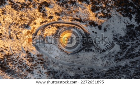 A bird's eye view of snow-covered Jested at sunrise. Photographed on the Jested ridge by drone. Beautiful winter landscape in Liberec region. Top down