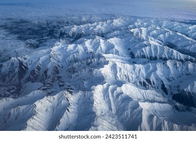 Bird's eye view of snowy mountain range - Powered by Shutterstock