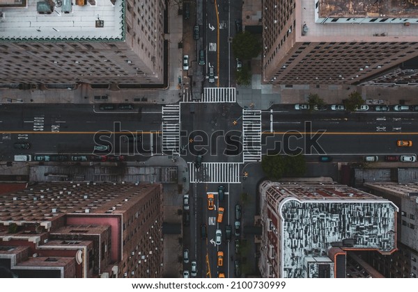 A bird\'s eye view of the traffic at the\
crossroad surrounded by\
skyscrapers