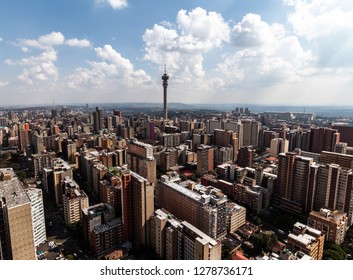 Birds Perspective On The Notorious City Of Hillbrow, One Of The Most Dangerous Parts Of Johannesburg In South Africa With The Telephone Tower In The Centre In Landscape Format On A Sunny Day