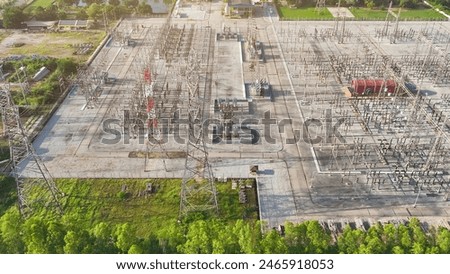 From a bird's-eye perspective, an electrical substation forms a mesmerizing geometric pattern, where wires and transformers create a symphony of electricity.
