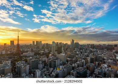 Bird's-eye view of a sunset cityscape depicting the Tokyo tower and Roppongi Hills skyscrapers above the buildings of Shibadaimon district at golden hour. - Shutterstock ID 2128294502
