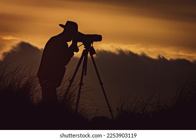 A birdwatcher at Sunset along The Breaches nature reserve - Shutterstock ID 2253903119