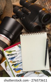 Birdwatching - Binoculars, camera, bird books and a notebook and pen - Space for text