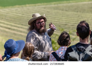 Birka, Sweden June 27, 2022 A Tour Guide And A Group Of Tourists On A Guided Tour Of The Old Viking Village.