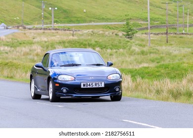 Birkhill, Scotland - JUNE 25, 2022: 2000 Blue Mazda MX5 Miata in a classic car rally travelling towards the town of Moffat, Dumfries and Galloway