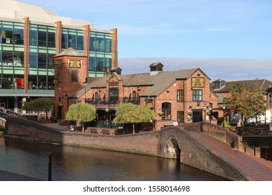 BIRMINGHAM, ENGLAND - OCTOBER 19, 2019: View of Birmingham Canal with The Malt House pub and Arena Birmingham, England