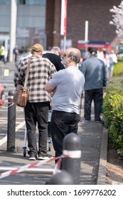 BIRMINGHAM, UK - 2020: Long Queues Of Shoppers During Coronavirus Social Distancing Measures In Covid-19 Virus Outbreak In The Midlands UK