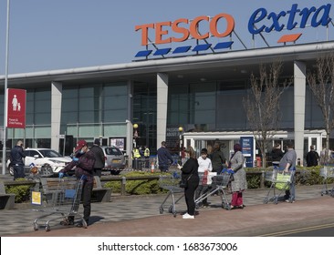 BIRMINGHAM, UK - 2020: Tesco Supermarket With Social Distancing Queue During The Coronavirus Pandemic