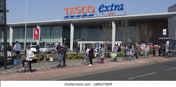 BIRMINGHAM, UK - 2020: Tesco supermarket with social distancing queue during the coronavirus pandemic