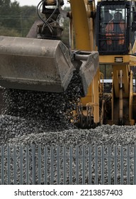 BIRMINGHAM, UK - 2022: A Railway Digger And Worker Moving Stone