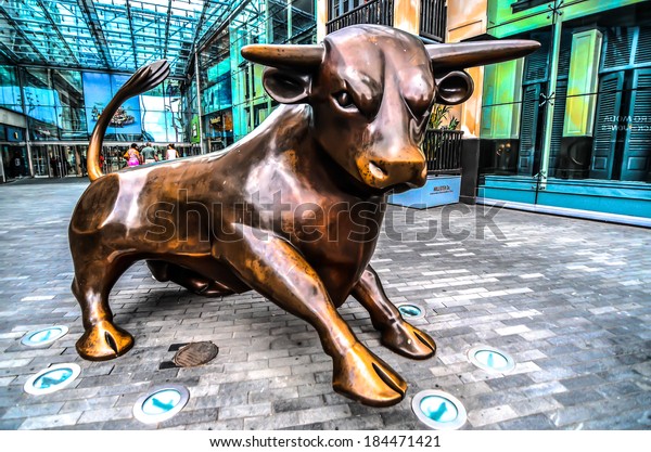 BIRMINGHAM, UK - 21 July 2013 : A Bull\
sculpture in front of Bullring Shopping Arcade, one of the landmark\
in Birmingham. This place attracts a lot of visitors from\
Birmingham itself and\
neighbors