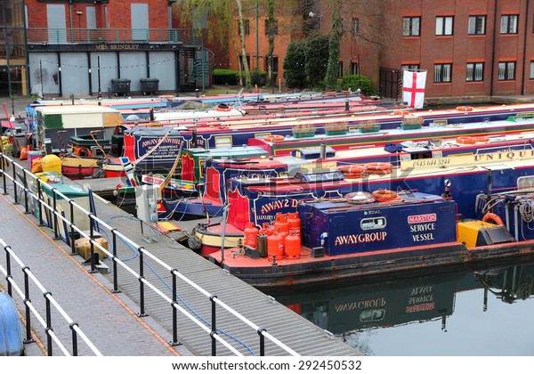 BIRMINGHAM, UK -\
APRIL 24, 2013: Narrowboats moored at Gas Street Basin in\
Birmingham, UK. Birmingham is the 2nd most populous British city.\
It has rich waterway and boat\
culture.