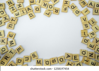 Birmingham, UK - December 2018: Scrabble Letters Around The Edge Of The Frame With Blank White Copy Space