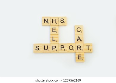 Birmingham, UK - December 2018: Scrabble Letters Spelling NHS, Help, Support, Care On A White Background