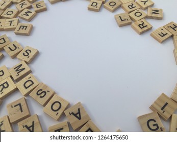 Birmingham, UK - December 2018: Scrabble Letters Around The Edge Of The Frame With Blank White Copy Space