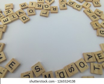 Birmingham, UK - December 2018: Scrabble Letters Around The Edge Of The Frame With Blank White Copy Space