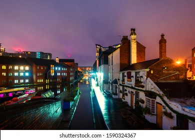 Birmingham, UK. Embankments During The Rain In The Night At Famous Birmingham Canal In UK. Cloudy Sky At Sunset