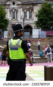 BIRMINGHAM, UK - JULY 28, 2022.  A Rear View Of An Asian Policeman In Uniform On The Street Of A UK City Showing Multicultural Diversity In The Police Force