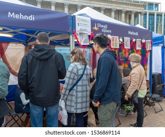 Birmingham, UK - October 19, 2019: Visitors Watch Mehndi Artists At A Stall During The Diwali On The Square Event.