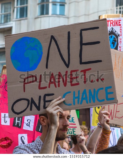 Birmingham, UK - September 20th 2019: A protester with a banner at the Climate Strike Protest March in the city of Birmingham, UK. 