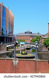 BIRMINGHAM, UNITED KINGDOM - JUNE 6, 2016 - View along the canal at Old Turn Junction with the National Indoor Arena to the left hand side, Birmingham, England, UK, Western Europe, June 6, 2016.