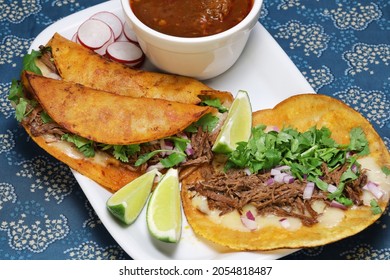 birria tacos with broth for dipping, mexican food