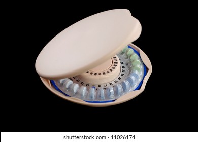 Birth Control Pills in a pink circular dispenser on a white background