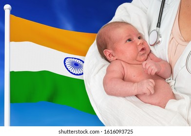 Birth Rate In India. Newborn Baby In Hands Of Doctor On National Flag Background.